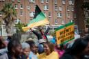 A man waves an ANC flag as supporters of the ruling party take part in a protest on March 26, 2014, in Cape Town