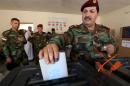 A member of the Kurdish Peshmerga force casts his ballot in special voting ahead of Iraq's upcoming election on April 28, 2014, in the northern Iraqi Kurdish city of Arbil