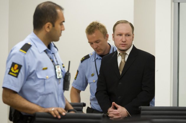 Confessed mass-murderer Anders Behring Breivik, right, enters court as the trial against him continues in Oslo, Norway, Tuesday May, 29, 2012. Three former friends of Breivik gave evidence Tuesday about his deep depression, living with his mother and his lack of social contacts while Breivik watched from an adjoining room. The terror trial continues against the anti-Muslim fanatic, Breivik, who has confessed to killing 77 people in July 2011, when he 8 people by setting off a bomb in central Oslo, and then shot to death 69 people on Utoya island, outside the Norwegian capital. (AP Photo / Heiko Junge, NTB scanpix) NORWAY OUT