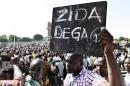 A man holds up a placard that reads in French, "Zida get out", referring to Isaac Zida, a high-ranking officer named by the military to lead the country's transition, during a protest in Ouagadougou on November 2, 2014