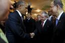 Barack Obama and Raul Castro shake hands as Ban Ki-moon looks on, before the inauguration of the VII Summit of the Americas in Panama City