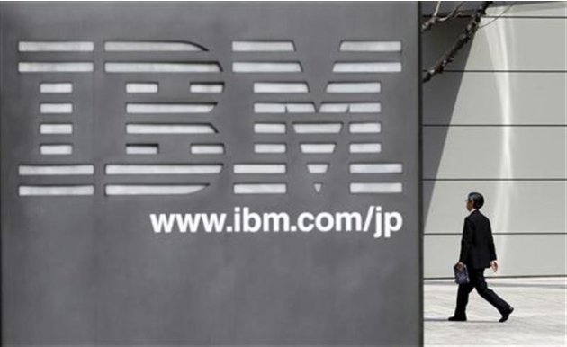 A man walks past the headquarters of IBM Japan in Tokyo