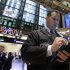 Trader Edward Curran, right, works on the floor of the New York Stock Exchange Monday, Dec. 5, 2011. Stocks rose broadly in early trading Monday on hopes for a plan to restore long-term confidence in the euro. (AP Photo/Richard Drew)