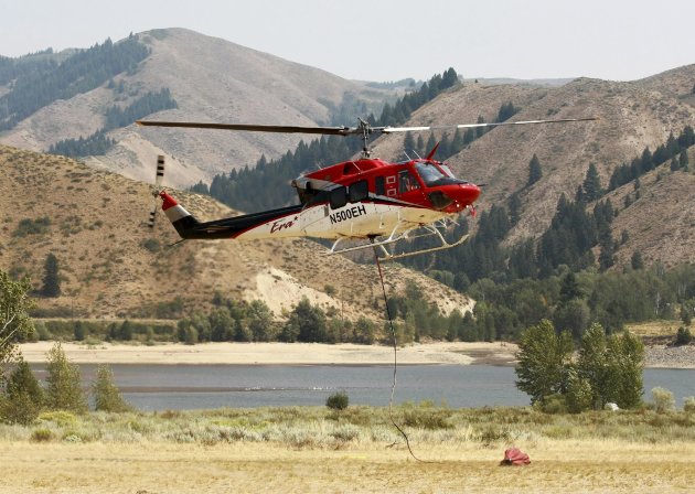 A water dropping helicopter leaves the heli-base while battling the Trinity Fire in Pine