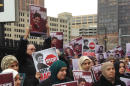Supporters of Rasmieh Odeh stand outside federal court in Detroit on Tuesday, Nov. 4, 2014. Odeh, associate director at Chicago's Arab American Action Network, is charged with failing to tell U.S. immigration about her conviction for bombings in Israel in 1969 that killed two people at a supermarket. Odeh's trial began Tuesday. (AP Photo/Ed White)