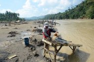 Miners pan for gold at a river near the typhoon disaster zone in Mawab town, Compostela Valley province, on December 9. Illegal gold mining and decades of logging contributed to the high death toll in the Philippines' worst natural disaster this year, experts say