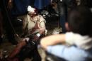 A wounded Syrian man is treated at a makeshift hospital in the rebel-held town of Douma, near Damascus, on September 11, 2014, after reported airstrikes by Syrian government forces