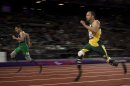 Brazil's Alan Fonteles Cardoso Oliveira, left, runs in to win the gold medal and beat South Africa's Oscar Pistorius, right, who took the silver medal in the men's 200m T44 category final during the athletics competition at the 2012 Paralympics, Sunday, Sept. 2, 2012, in London. (AP Photo/Emilio Morenatti)