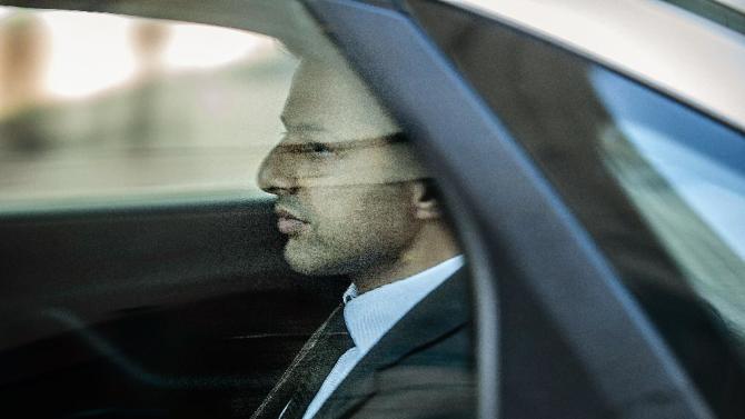 British millionaire Shrien Dewani sits in a car leaving the Cape Town High Court on October 6, 2014, after the first day of his trial for allegedly murdering his young bride