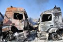 Carcasses of burnt-out lorries at the Bab al-Hawa border post with Turkey, July 20