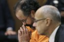 Ariel Castro looks down during court proceedings Friday, July 26, 2013, in Cleveland. Castro, who imprisoned three women in his home, subjecting them to a decade of rapes and beatings, pleaded guilty Friday to 937 counts in a deal to avoid the death penalty. Defense attorney Jaye Schlachet is on the right. (AP Photo/Tony Dejak)