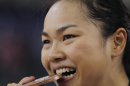 Wai Sze Lee of Hong Kong bites the bronze medal after the track cycling women's keirin event, during the 2012 Summer Olympics in London, Friday, Aug. 3, 2012. (AP Photo/Christophe Ena)