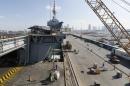 Work is carried out around the French aircraft carrier Charles de Gaulle during a port call in Abu Dhabi
