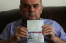 Fuad Sharef shows his US immigrant visa in Arbil, the capital of the Kurdish autonomous region in northern Iraq, on January 30, 2017