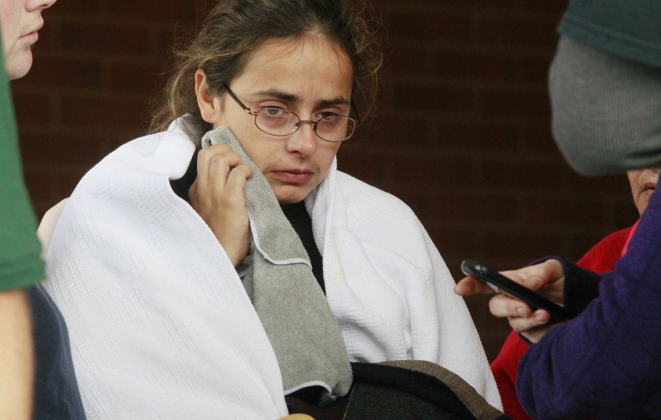 Anna Angel, right, is comforted by family while exiting Tiffin Mercy Hospital on Sunday, Sept. 15, 2103 in Tiffin, Ohio. Angel is the mother of the five children that were killed during the fire that swept through a mobile home Sunday in Tiffin, Ohio. The fire also killed a man that is reported to be Angel's boyfriend. (AP Photo/The Blade, Amy Voigt)