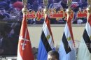 Egypt's new President Mursi delivers a speech during a ceremony where the military handed over power to Mursi at a military base in Hikstep