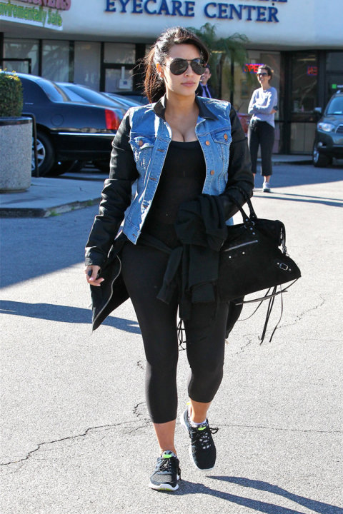 Kim Kardashian wore this denim jacket with leather sleeves over the top of her gym kit. Copyright [Splash]