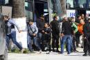 Tourists and visitors from the Bardo museum are evacuated in Tunis, Wednesday, March 18, 2015 in Tunis, Tunisia. Gunmen opened fire at a leading museum in Tunisia's capital, killing 19 people including 17 tourists, the Tunisian Prime Minister said. A later raid by security forces left two gunmen and one security officer dead but ended the standoff, Tunisian authorities said. (AP Photo/Hassene Dridi)