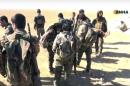 This frame grab from video provided on Monday, Nov. 7, 2016, by the Hawar News Agency, shows U.S.-backed fighters deployed during fighting with the Islamic State group in the village of Laqtah, north of Raqqa, Syria. Turkey said Tuesday that Washington has promised that U.S.-backed Syrian Kurdish forces will only be involved in encircling the Islamic State stronghold of Raqqa and will not enter the city itself. (Hawar News Agency, via AP)
