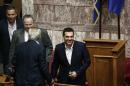 Greece's Prime Minister Alexis Tsipras, right, enters the main parliament hall ahead of a parliament vote on a new austerity reform package in Athens, Oct. 17, 2015. Tsipras faces his first test in the country's newly elected parliament Friday since a bailout rebellion split his party and triggered a snap general election last month. (AP Photo/Yorgos Karahalis)