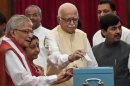 Senior Bhartiya Janata Party President L.K. Advani (C) casts his vote during the election for Vice President