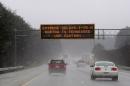 A Georgia transportation sign warns motorists on Interstate 75 on Tuesday, Feb. 11, 2014, in Kennesaw, Ga., about 20 miles north of metro Atlanta. A winter snow storm is blowing into Georgia in what the National Weather Service predicted to be "an event of historical proportions." (AP Photo/David Tulis)