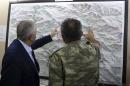 FILE - In this Monday, Sept. 5, 2016 photo, an army commander informs Turkey's Prime Minister Binali Yildirim, left, on a Turkey-Iraq border map, in Cukurca, Turkey. Iraq's Foreign Ministry has summoned Turkeys' ambassador to Baghdad over "provocative" comments by Turkish Prime Minister Binali Yildirim about the planned operation to dislodge Islamic State militants from the city of Mosul. (Prime Ministry Press Service, Pool photo via AP, File)