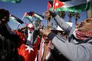 Jordanians chant slogans to show their support for the government against terror as they were waiting for Jordan's King Abdullah II, returning from the U.S., at Queen Alia Airport in Amman, Jordan, Wednesday, Feb. 4, 2015. King Abdullah II rushed home Wednesday, cutting short a U.S. trip, to rally public support for even tougher strikes against the Islamic State group after the militants released a video showing the captured Jordanian pilot being burned to death in a cage. (AP Photo/Raad Adayleh)