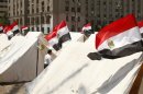A protester walks among tents set up by protesters for their sit-in at Tahrir Square in Cairo