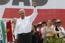 Election runner-up Lopez Obrador waves to supporters as he arrives to a rally at the Zocalo main square in Mexico City