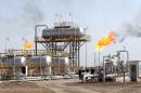 Engineers work at the Naher al-Umran gas refinery, in the el-Dir district, north of Basra, on July 17, 2009