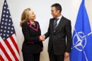 U.S. Secretary of State Hillary Rodham Clinton, left, shakes hands with NATO Secretary-General Anders Fogh Rasmussen at the NATO headquarters in Brussels Tuesday Dec. 4, 2012. (AP Photo / Kevin Lamarque)