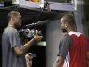 Miami Heat small forward LeBron James, left, points a video camera at shooting guard Dwyane Wade after a news conference following basketball practice on Saturday, June 8, 2013, at the American Airlines Arena in Miami. The Heat and the San Antonio Spurs are to play Game 2 of the NBA Finals, Sunday. (AP Photo/Wilfredo Lee)
