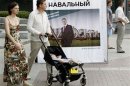 People pass by a banner, part of Russian opposition leader and anti-corruption blogger Alexei Navalny's mayoral election campaign, in Moscow