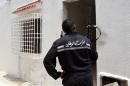 A Tunisian gendarme stands guard outside a house where two suspected jihadists were killed during a security operation on May 11, 2016 in the town of Mnihla just outside Tunis