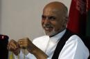 Afghan presidential candidate Ashraf Ghani Ahmadzai smiles during a news conference in Kabul