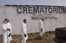 In this Saturday, March 7, 2015 file photo, health workers prepare to collect the ashes of people that died due to the Ebola virus at a crematorium on the outskirts of Monrovia, Liberia. As Liberia marks the second anniversary Wednesday of its first confirmed Ebola cases, many neighbors say they want to see the crematorium torn down so they can try to forget that terrible time. (AP Photo/ Abbas Dulleh, File)