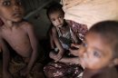 Rohingya children, who fled the recent violence of Myanmar, sit in a house as they hide with other relatives in Teknaf