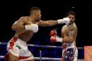 British boxer Anthony Joshua, left, fights U.S. boxer Dominic Breazeale during their IBF heavyweight title bout at the O2 Arena in London, Saturday, June 25, 2016. (AP Photo/Matt Dunham)
