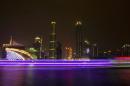 A long exposure picture of boats passing by a business area along the Pearl River in Guangzhou, Guangdong province