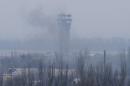 Smoke rises near the traffic control tower of the Sergey Prokofiev International Airport damaged by shelling during fighting between pro-Russian separatists and Ukrainian government forces, in Donetsk