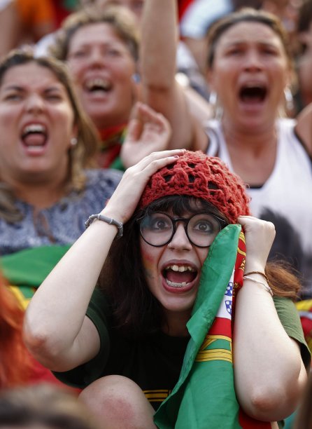 Portuguese soccer fans react during the semi final Euro 2012 soccer match between the Portugal and Spain at a public screening in Lisbon