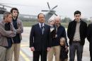 French President Francois Hollande, third from left, speaks with released French hostages, from left, Didier Francois, Edouard Elias, Nicolas Henin and Pierre Torres, at the Villacoublay military airbase, outside Paris, Sunday, April 20, 2014. The four French journalists kidnapped and held for 10 months in Syria returned home on Sunday to joyful families awaiting them. The four were freed by their captives a day earlier at the Turkish border. (AP Photo/Jacques Brinon)