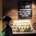 An Indian employee of the newly inaugurated first India outlet of Starbucks stands at the store in Mumbai, India, Friday, Oct. 19, 2012. Starbucks inaugurated its first store in India Friday in a historic building in southern Mumbai as the Seattle-based coffee giant seeks growth in a market long associated with tea drinkers. (AP Photo/Rajanish Kakade)
