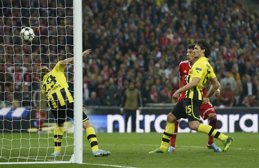 Bayern's Mario Mandzukic of Croatia, background center, scores the opening goal,  during the Champions League Final soccer match between Borussia Dortmund and Bayern Munich at Wembley Stadium in Londo