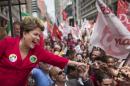Brazil's President Dilma Rousseff, who is running for reelection with the Workers Party, greets supporters at a campaign rally in Porto Alegre, Brazil, Saturday, Oct. 25, 2014. Brazilians will go to the polls on Sunday to decide who'll be the next leader of Latin America's biggest economy. (AP Photo/Felipe Dana)