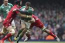 Ireland's Jared Payne, centre, gets tackled as he tries to break through the Wales defence during the Six Nations rugby union match at the Millennium Stadium, Cardiff, Wales, Saturday March 14, 2015. (AP Photo/David Davies/PA) UNITED KINGDOM OUT