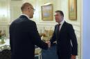 Ukraine's Prime Minister Yatseniuk greets NATO Secretary General Rasmussen during their meeting in Kiev