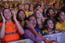 Fans of the Brazil national soccer team react after the Netherlands scored a goal during a live broadcast of the World Cup third-place soccer match between Brazil and Netherlands, inside the FIFA Fan Fest area on Copacabana beach, Rio de Janeiro, Brazil, Saturday, July 12, 2014. Robin van Persie and Daley Blind scored early goals to help give the Netherlands a 3-0 win over host Brazil in the third-place match at the World Cup. (AP Photo/Silvia Izquierdo)