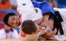 Germany's Ole Bischof (white) competes with South Korea's Kim Jae-Bum